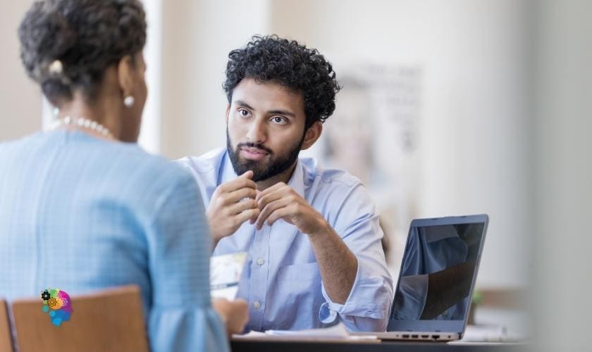 A manager attentively listening to an employee in a post about how to be a better boss