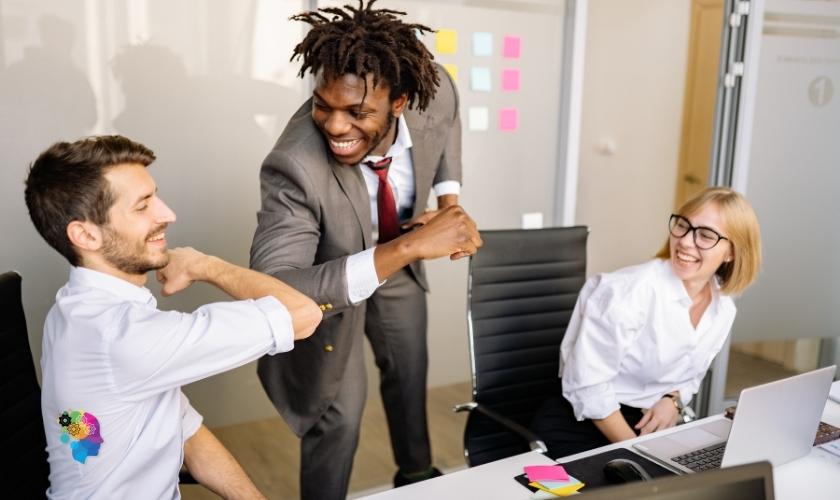 A cheerful boss greeting team members  in a post about how to be a better boss