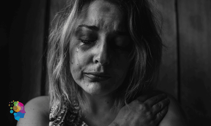 Tearful woman with mascara streaming down her face, symbolizing emotional trauma responses in relationships.