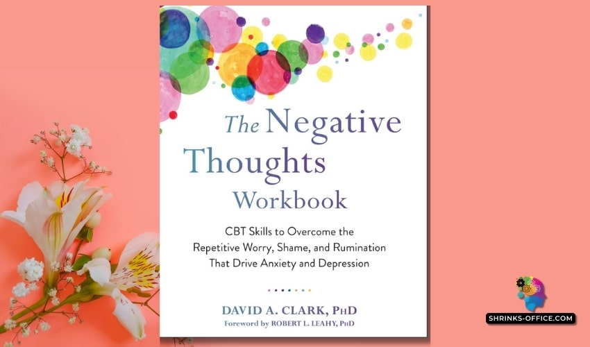 The cover of 'The Negative Thoughts Workbook' by David A. Clark, Ph.D., featuring colorful watercolor splashes above white lilies on a coral background.